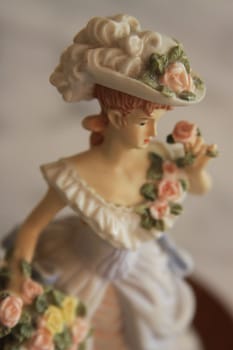 Antique figurine close up over background.