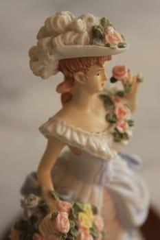 Antique figurine close up over background.