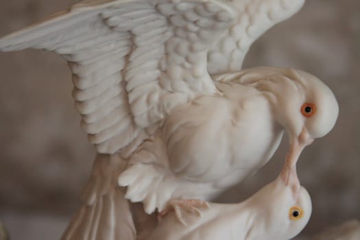 Dove antique figurine close up over background.