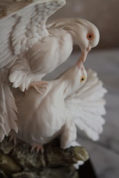 Dove antique figurine close up over background.