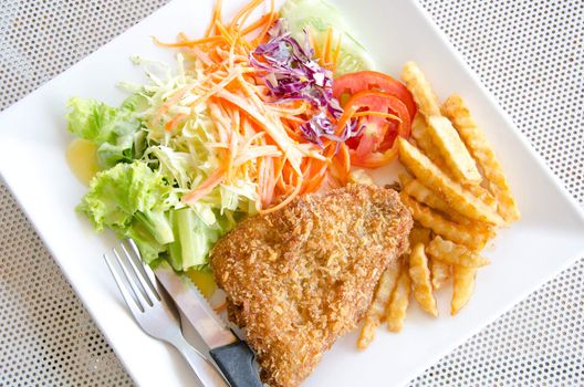 Fried fish. Served with potato and salad.