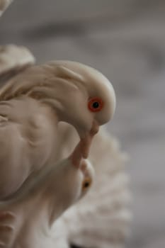 Dove antique figurine close up over background.