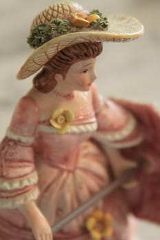 Antique figurine close up over background.