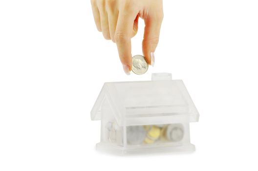 Hand with coin and house bank isolated on white background