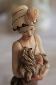 Antique figurine close up over background.