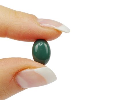 hand holds pill isolated on white