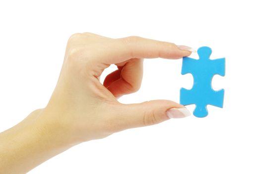 hand holding a puzzle piece