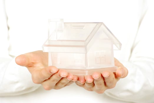 The house in human hands on white