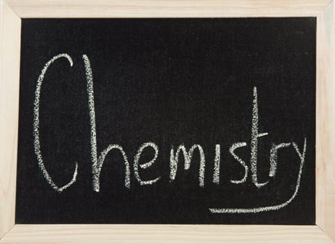 A black board with a wooden frame and the word 'CHEMISTRY' written in chalk.