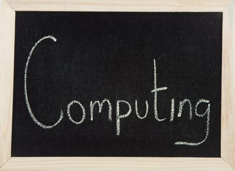 A black board with a wooden frame and the word 'COMPUTING' written in chalk.