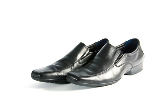 Black leather shoes on white background.