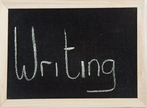 A black board with a wooden frame and the word 'WRITING' written in chalk.