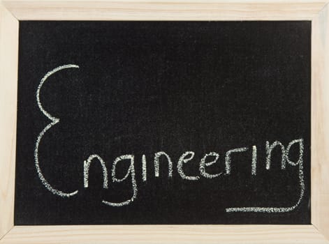 A black board with a wooden frame and the word 'ENGINEERING' written in chalk.