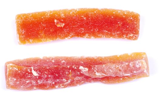 orange dried papaya slices over white background