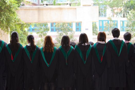 Back of university graduates with their gowns