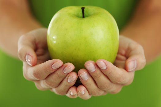 green apple in woman hands