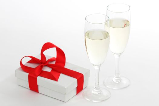 white gift with red ribbon