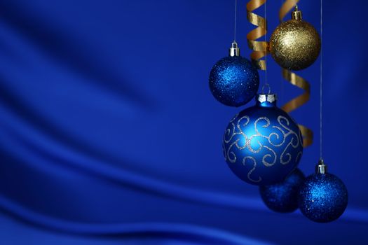 christmas balls on blue satin background