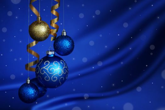 christmas balls on blue satin background