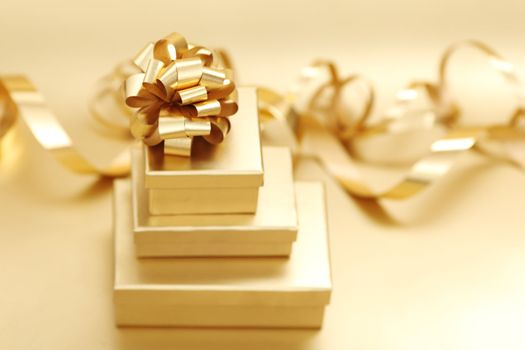 golden christmas gifts on gold background 