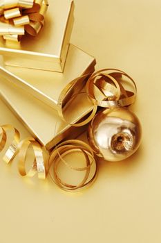 golden christmas gifts on gold background 