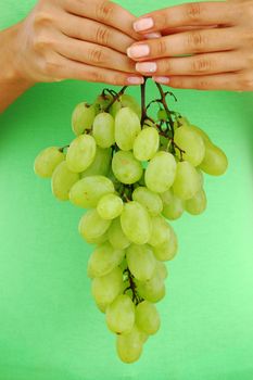 grape in woman hands close up