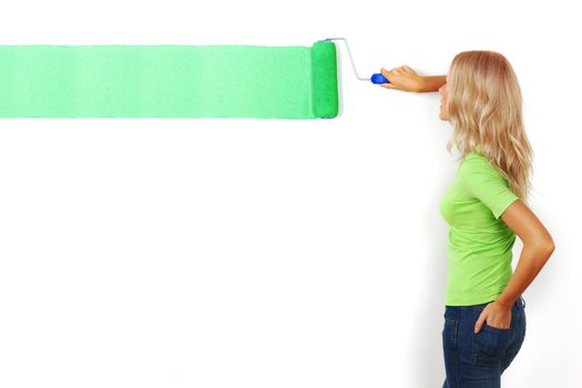 woman paints the wall brush