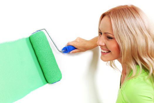 woman paints the wall brush