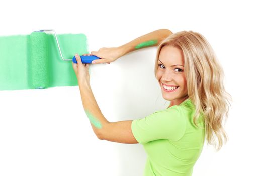 woman paints the wall brush