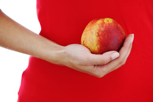 peach in woman hands close up