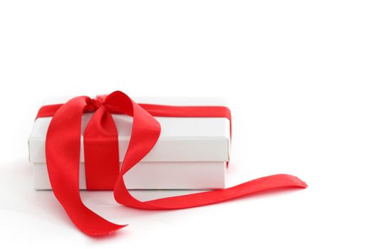 white christmas gift with red ribbon