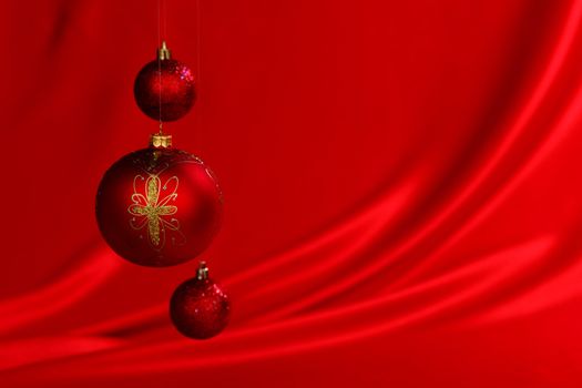  christmas balls on red satin background