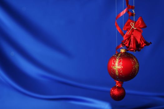 red christmas balls on blue satin background