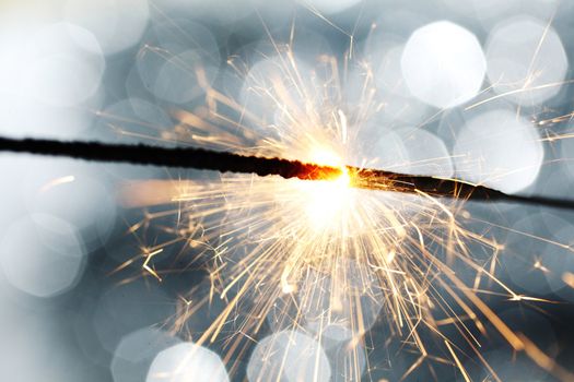 sparkler on silver bokeh background macro close up