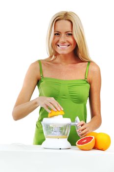 woman squeezes juice by juicer