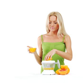 woman squeezes juice by juicer