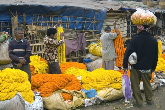 People buying and selling flowers at the flower market in Kolkata, West Bengal, India