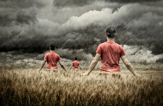 Young peoples touching spikes of wheat while is raining -NOTE-High contrast photography/Grain was added