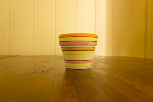 Little clay flower pots with color stripes.