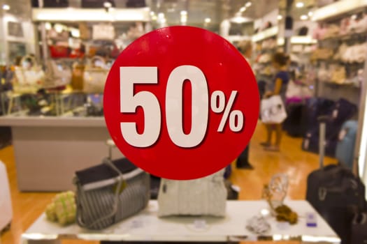 Fifty percent off sale on a shop window.