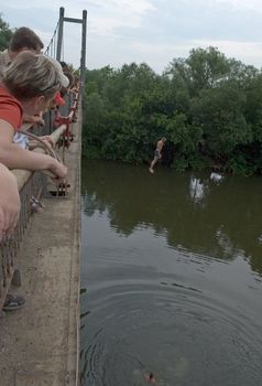 crazy man jumps from the high bridge in the river
