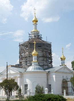A under construction orthodox church with blue sky at background