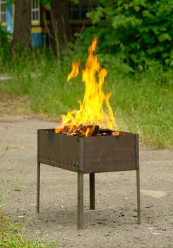 small road mangal with the burning firewood