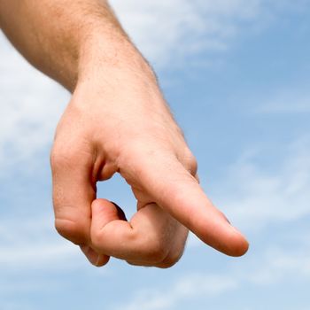 finger. hand gesture with blue sky at background