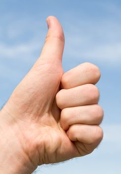Thumbs up on a blue sky background