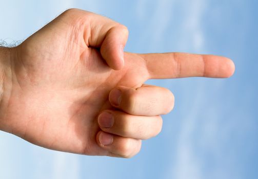 finger. hand gesture with blue sky at background