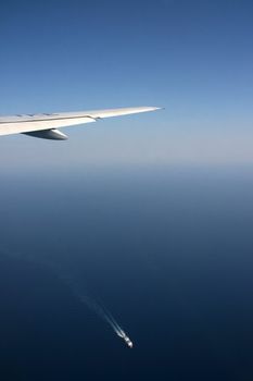 transportations airplane flying and ship shipping over aegian greece