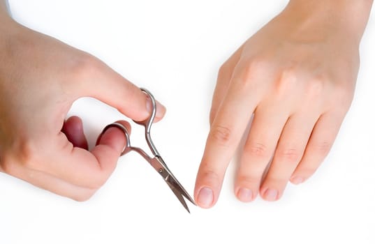 Closeup. Female hands make manicure.