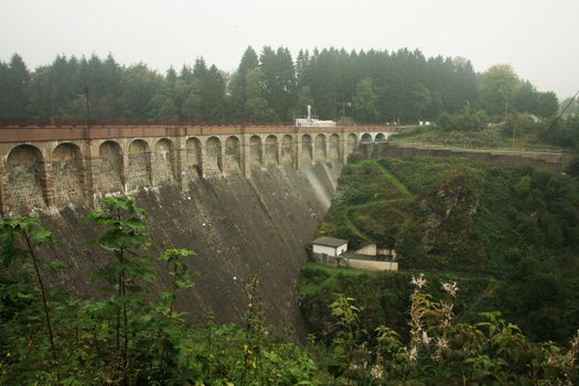 Dam in near Robertville village – gloomy day in Ardennes Mountain – Belgium.