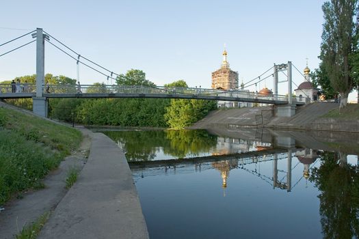 Suspension bridge with orthodox temple at background